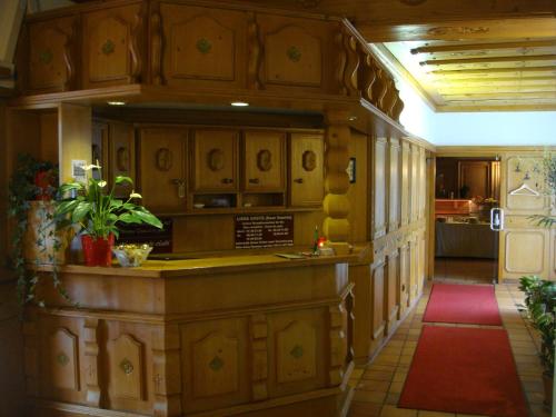 a kitchen with wooden cabinets and a red rug at Hotel Smart-Inn in Erlangen
