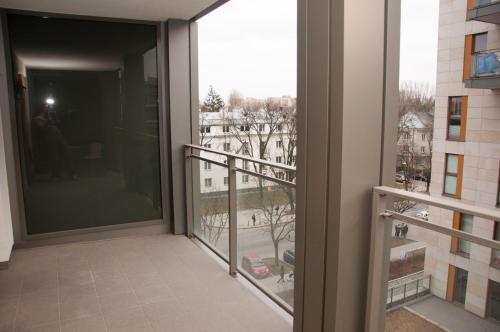 a balcony with a view of a building at Apartament Obrzeżna 3 Deluxe in Warsaw