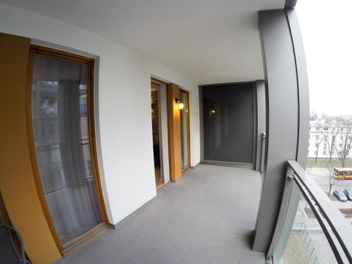a hallway of a building with glass doors at Apartament Obrzeżna 3 Deluxe in Warsaw