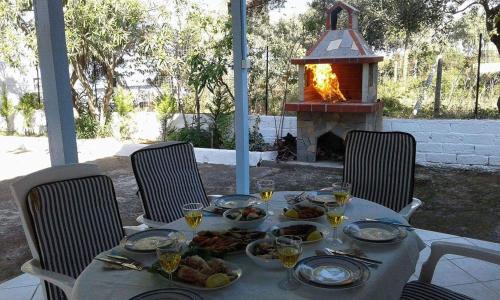 a table with plates of food and a fireplace at Villa Valia in Skala Kallirakhis
