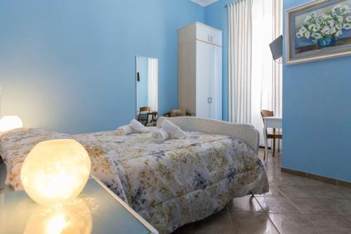 a bedroom with a bed and a table with a lamp at Albachiara Guest House in Rome