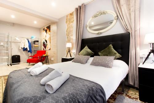 1 dormitorio con 1 cama grande y espejo en Font 2 Circo Romano, en Tarragona
