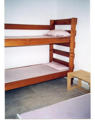 two bunk beds in a room with a table at La Loma in Melgar