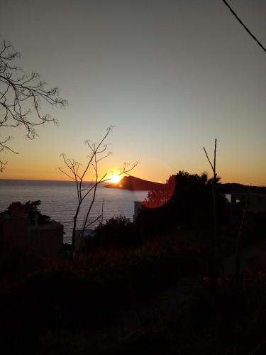 a sunset over the water with the sun in the sky at Sunset in Kalymnos