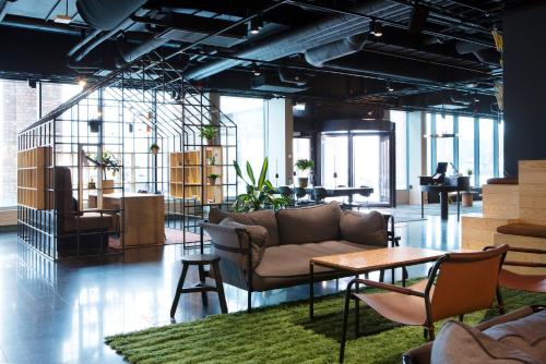 a living room with a couch and chairs and tables at Comfort Hotel Västerås in Västerås