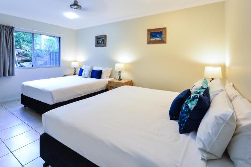 a bedroom with two beds and a window at Blue Water Views on Hamilton Island by HIHA in Hamilton Island