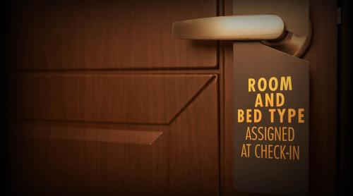 a sign on the wall of a bathroom with a room and bed type assigned at at Golden Nugget Hotel & Casino Las Vegas in Las Vegas