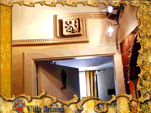 a mirror with a gold frame on a wall at Villa Arianna B&B in Taormina
