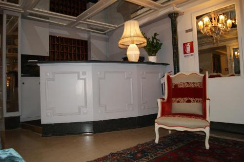 a room with a counter with a chair and a lamp at Hotel Il Moro di Venezia in Venice