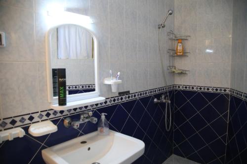 a bathroom with a sink and a mirror at Popov Guest House in Balchik