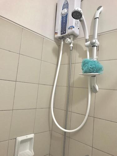 a shower in a bathroom with a urinal at Camella Northpoint Condo Studio in Davao City
