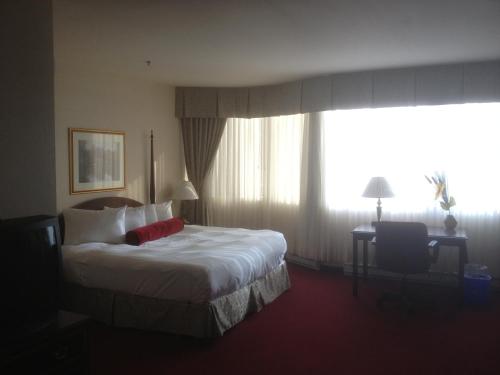 a hotel room with a bed and a large window at Hotel Chrome Montreal Centre-Ville in Montréal