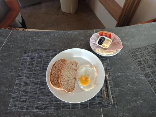 a plate with an egg and two slices of bread at Ander Divers Garden Resort in Anda