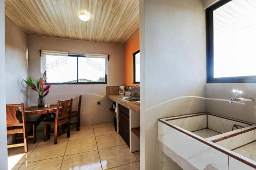 a kitchen with a table and a dining room at Casa Monarca - Monteverde in Monteverde Costa Rica