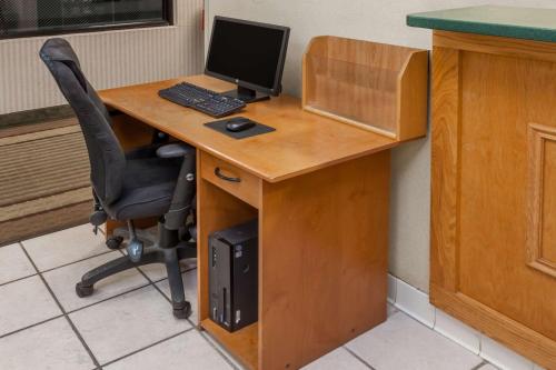 a desk with a computer on top of it at Super 8 by Wyndham Huntington in Huntington