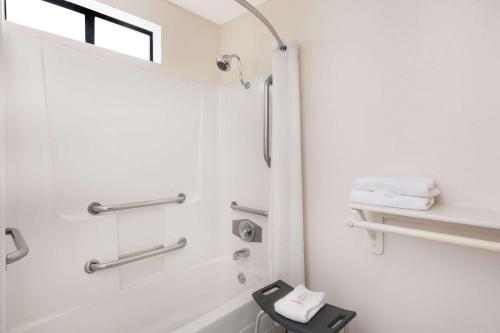 a bathroom with a shower and a sink at Super 8 by Wyndham Corning in Corning