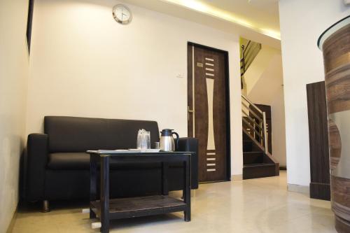 a room with a table and a chair and a door at Hotel K.C Residency in Mumbai