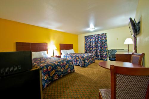 En eller flere senger på et rom på Passport Inn and Suites - Middletown