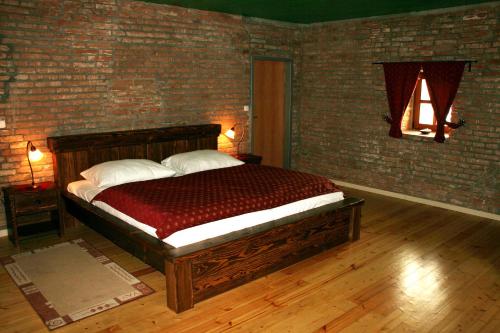 a bedroom with a large bed in a brick wall at Chateau Krakovany in Krakovany