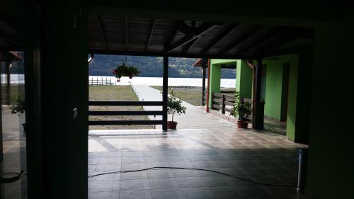 an open door to a building with a view of the water at Pensiunea Lorena in Cozla