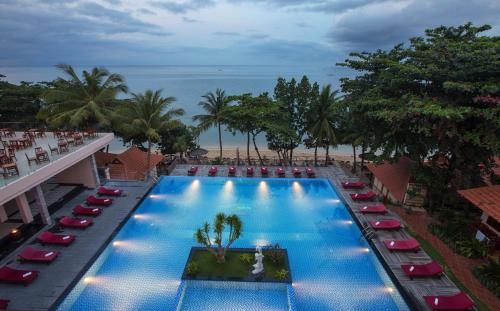 an overhead view of a swimming pool with lounge chairs and the beach at Kim Hoa Resort in Phu Quoc