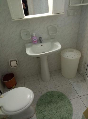 a bathroom with a white sink and a toilet at Soulas apart -Ρέα- in Ano Syros