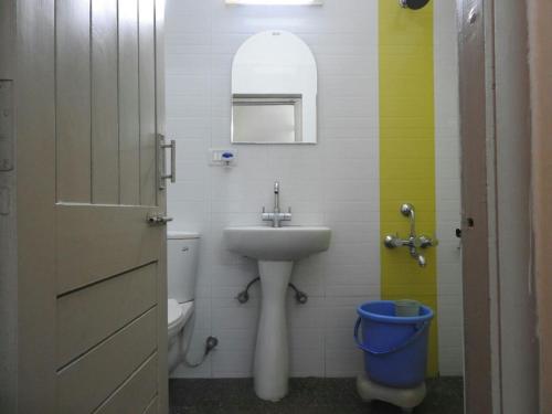 a small bathroom with a sink and a toilet at Rising Sun Retreat in Mount Ābu