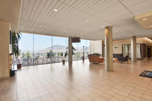 an empty lobby with a view of a mountain at Residence & Conference Centre - Kamloops in Kamloops