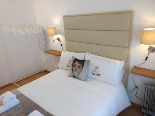 a bed with a picture of a person with a mask on it at ML Apartments Avenue in Porto