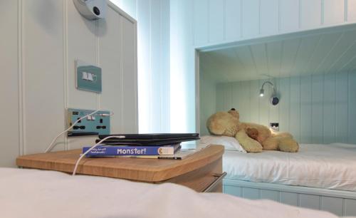 two teddy bears sitting on top of a bed at Luccombe Hall Hotel in Shanklin