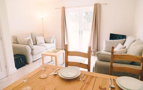 a living room with a table and a couch at Tennyson Cottage in Freshwater