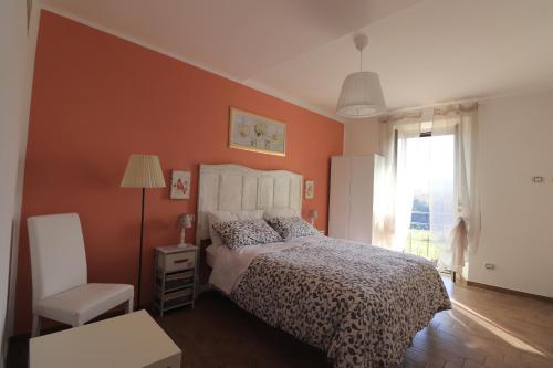 a bedroom with a bed and a chair and a window at Platea Oche in Sutri