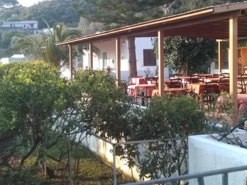 a restaurant with tables and chairs on a building at Villa Petrusa in Stromboli