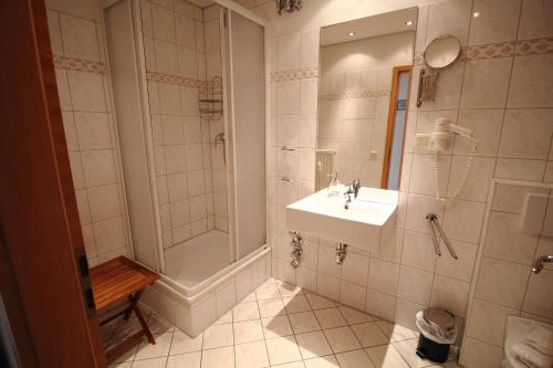 a bathroom with a sink and a shower and a sink at Fuerstenhof Appartement 401 in Sassnitz