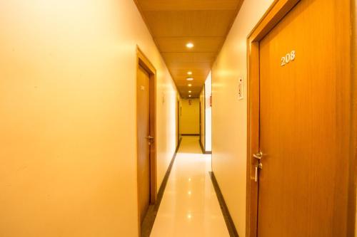 a corridor of an office building with a long hallway at Accord Hotel in Mumbai
