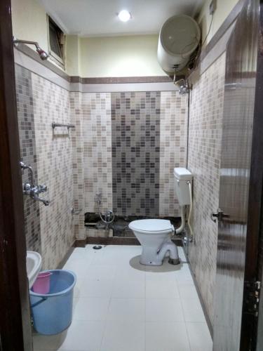 a bathroom with a toilet and a sink at Hotel Raj Palace in Dibrugarh