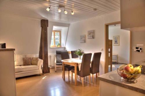 a kitchen and living room with a table and chairs at Ökonomiehof in Lichtenfels