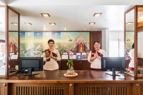 three women standing behind a counter in a room at Samui Paradise Chaweng Beach Resort in Chaweng
