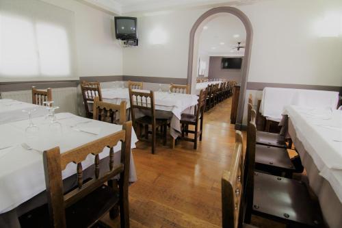 a dining room with tables and chairs and a mirror at Hotel Restaurante Irubide in Alsasua