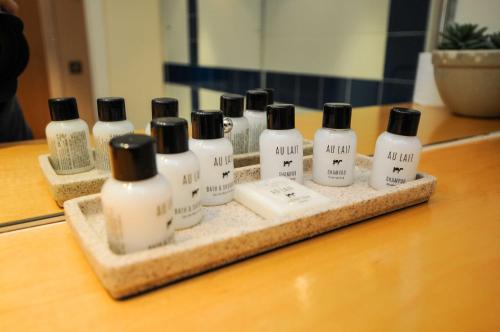 a group of bottles on a tray on a counter at Hamilton Court Apartments from Your Stay Bristol in Bristol