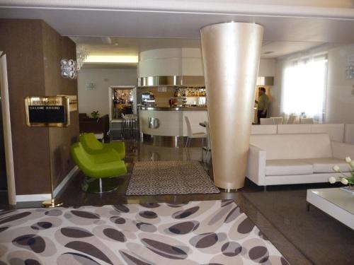 a living room with a couch and a table at Hotel Desenzano in Desenzano del Garda