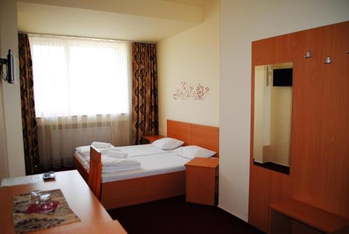 Cette petite chambre comprend 2 lits et une fenêtre. dans l'établissement CT Tm, à Timişoara