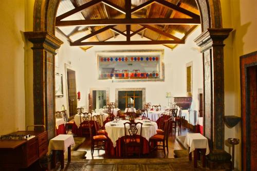 a dining room with tables and chairs in a building at Hotel Convento Nossa Senhora do Carmo in Freixinho