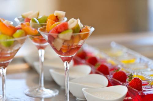a group of wine glasses filled with fruit on a table at Mayia Exclusive Resort & Spa - Adults Only in Kiotari