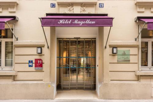 a entrance to a building with a purple awning at Hôtel Magellan in Paris