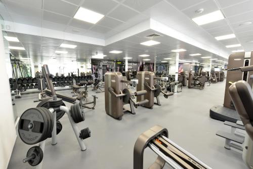 a gym with several rows of treadms and machines at Maximus Hotel Byblos in Jbeil