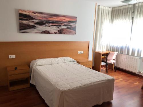 A bed or beds in a room at Hostal El Poligono