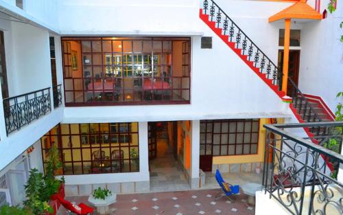 a building with a staircase and a room with chairs at Hotel Harmony in Khajurāho