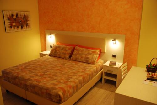 a bedroom with a bed and a night stand with a table at Agriturismo Le Risaie in Basiglio
