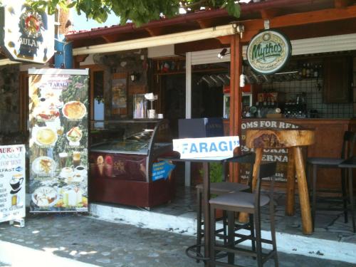 a restaurant with tables and chairs in front of it at Faragi in Agia Roumeli
